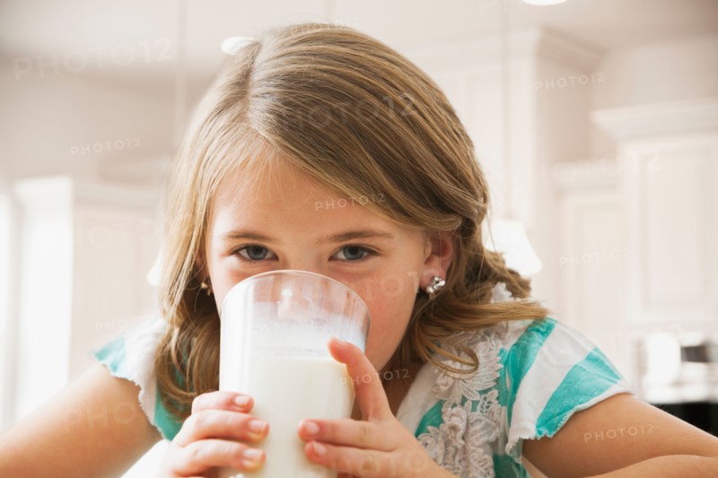 Girl (6-7) drinking milk