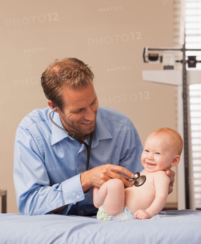 Pediatrician listening heartbeat of baby boy (2-5 months)