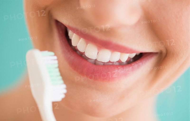 Close-up of woman brushing teeth.