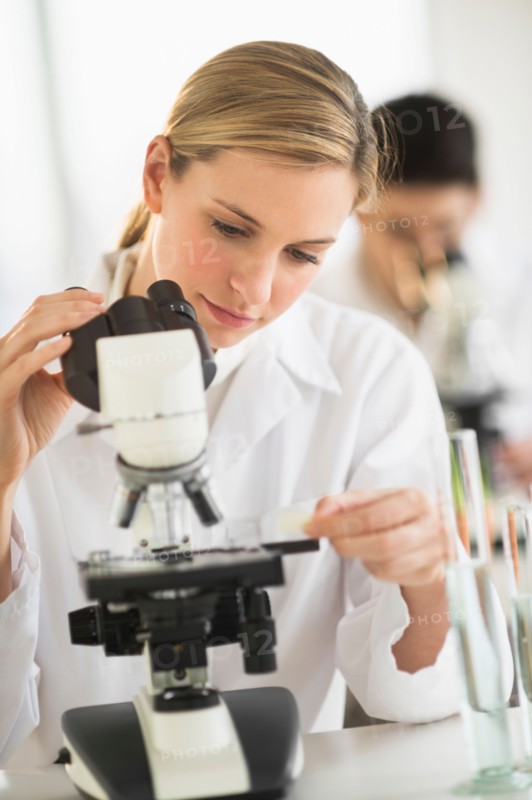 Scientists doing research on microscopes.