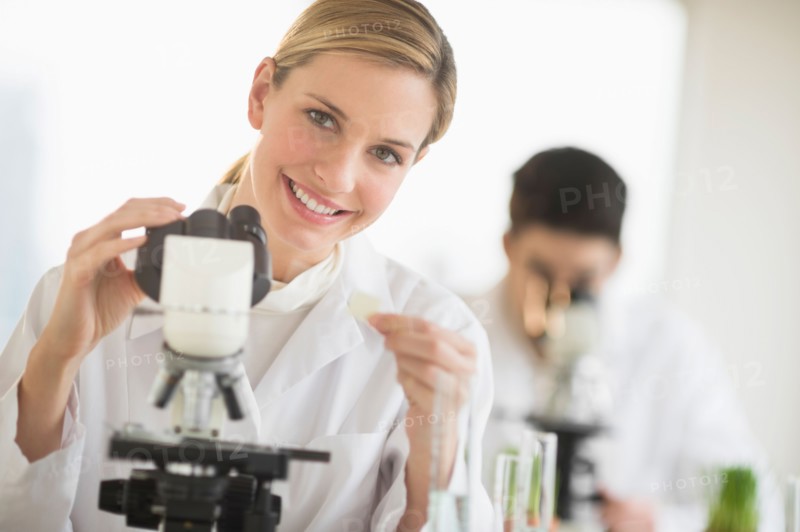 Scientists doing research on microscopes.