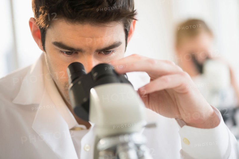 Scientist doing research on microscopes.
