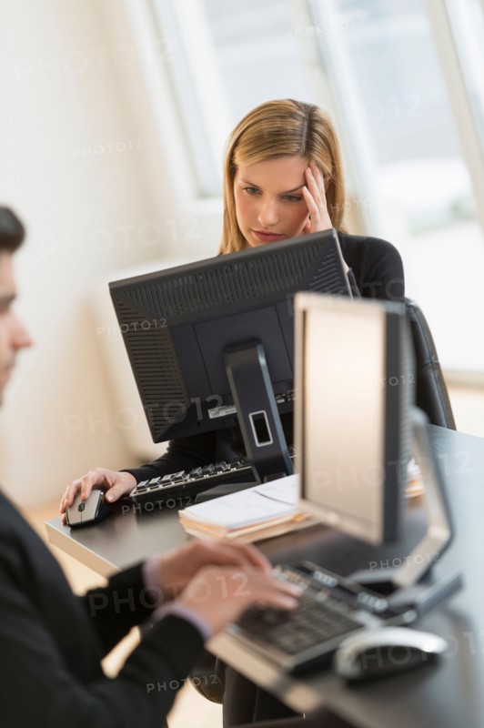 Business man and woman working in office.