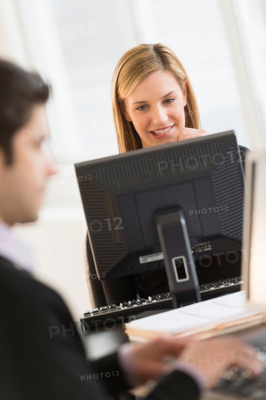 Business man and woman working in office.