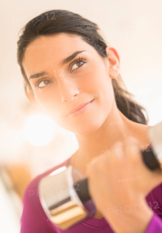 Woman lifting dumbbell.