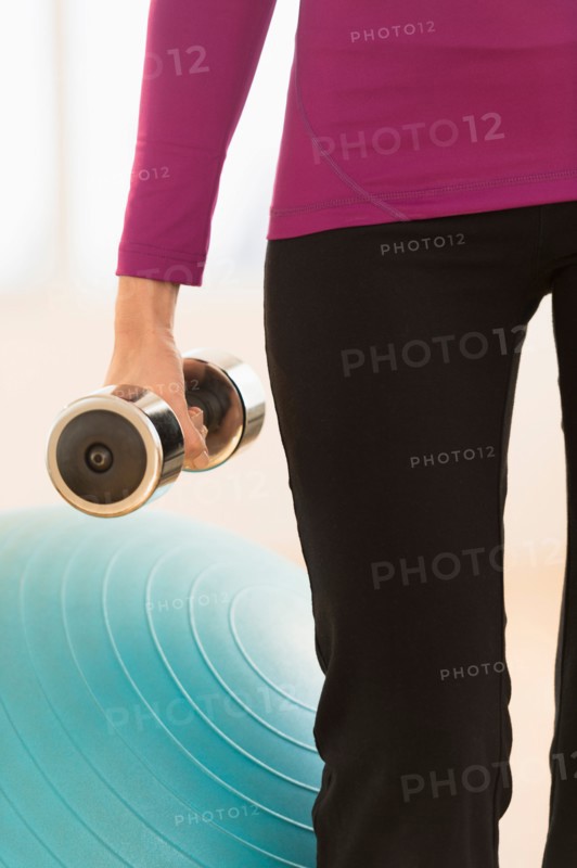 Woman holding dumbbell.
