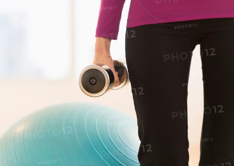 Woman holding dumbbell.