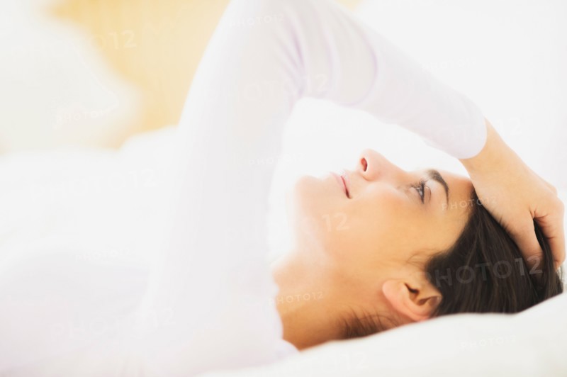 Woman lying in bed.