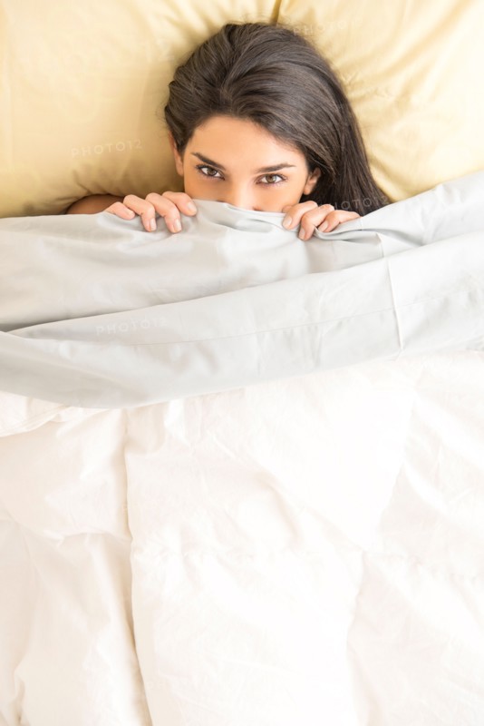 Woman lying in bed.
