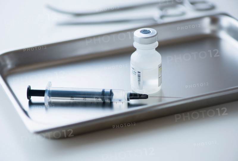 Close up of syringe and medication, studio shot.