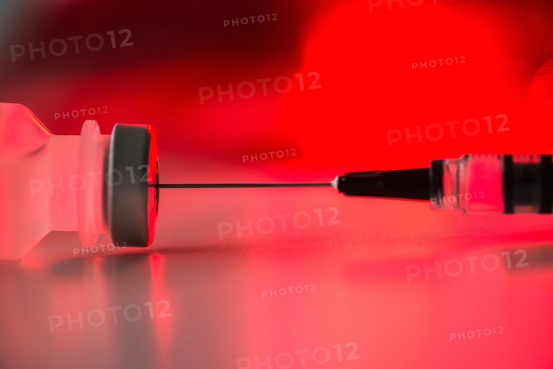 Close up of syringe and medication, studio shot.