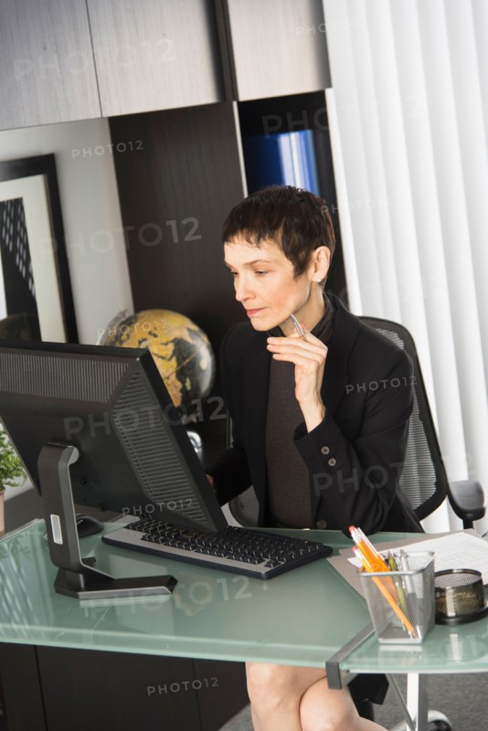 Businesswoman working at desk.