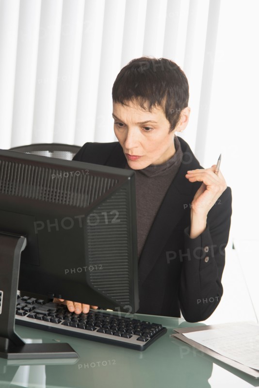 Businesswoman working at desk.