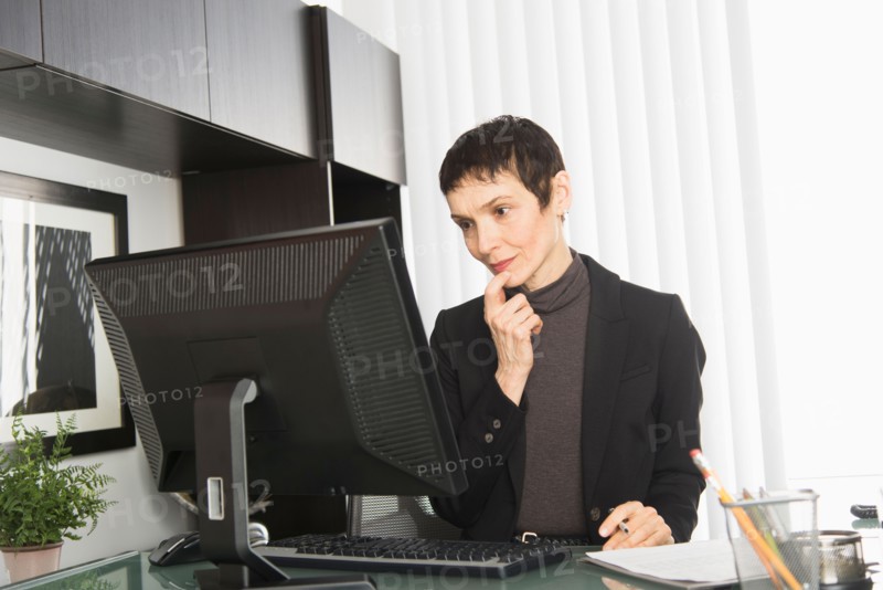 Businesswoman working at desk.