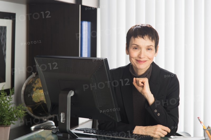 Portrait of businesswoman at desk.