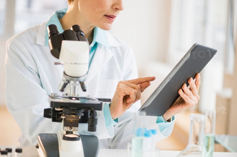 Woman using digital tablet in laboratory.