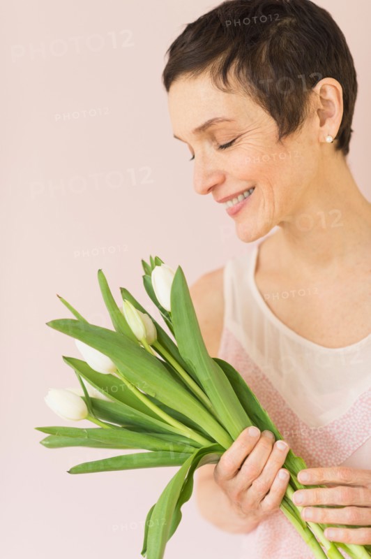 Portrait of mature woman with tulips.