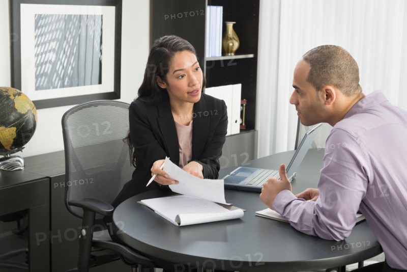 Man and woman at meeting in office.