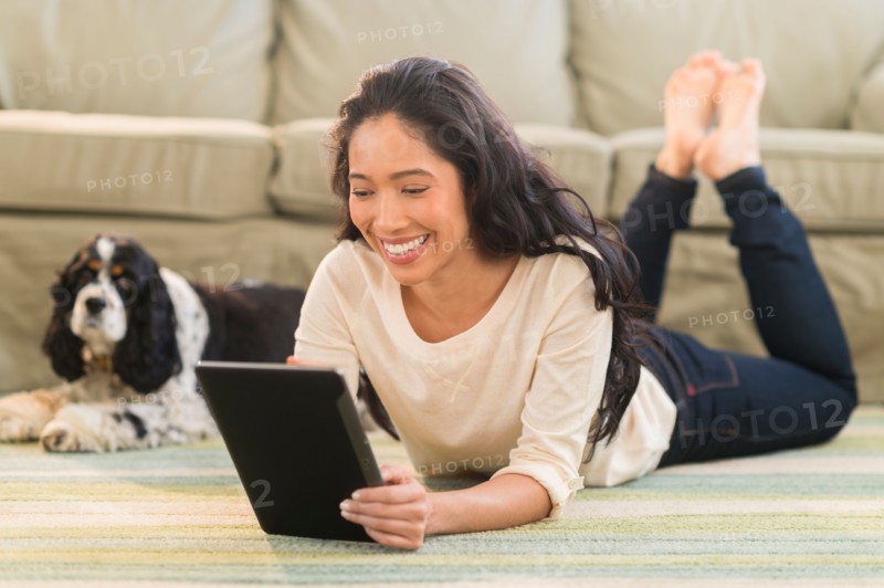Young woman with dog in livingroom.