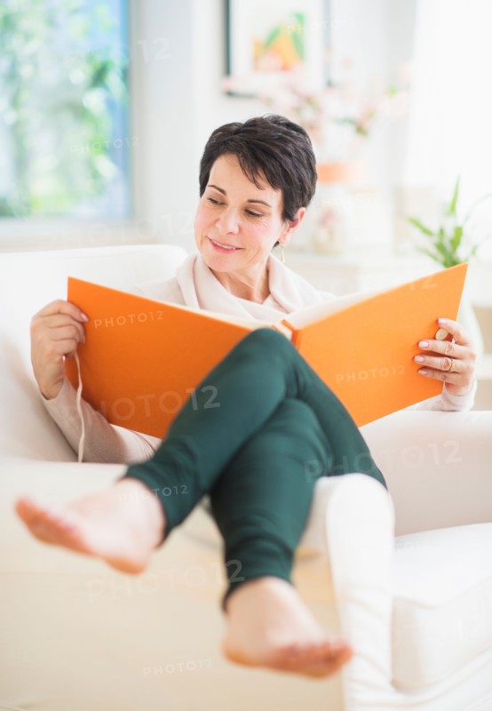 Portrait of mature woman looking at photo album