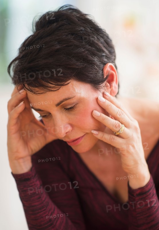Portrait of mature woman with hands on head