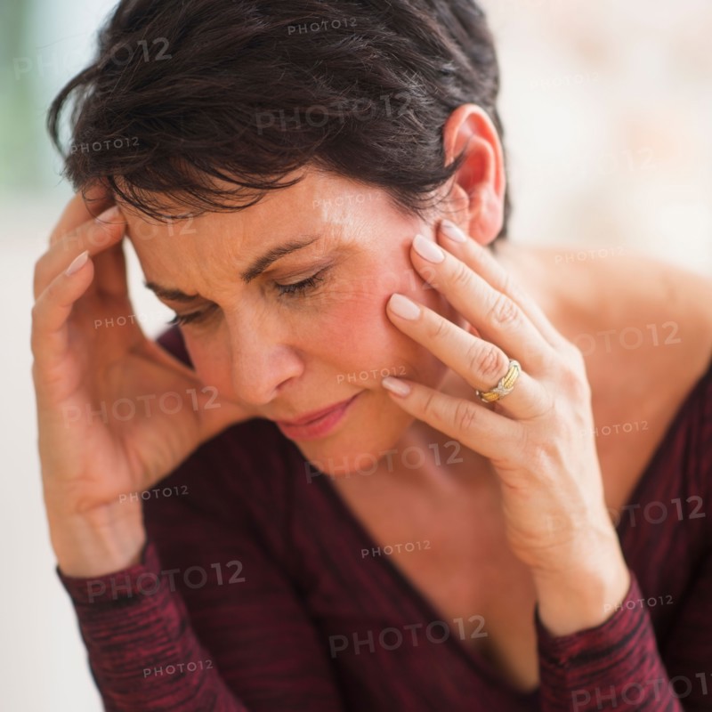 Portrait of mature woman with hands on head