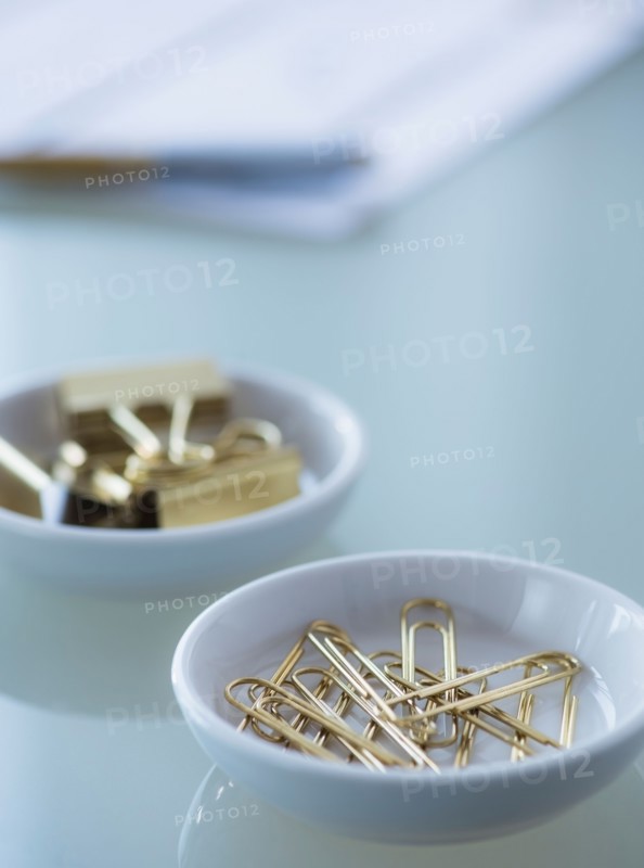 Close-up of paper clip and binder clip