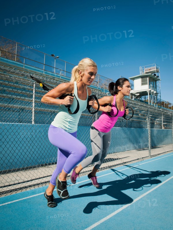 Two women using resistance band during exercise