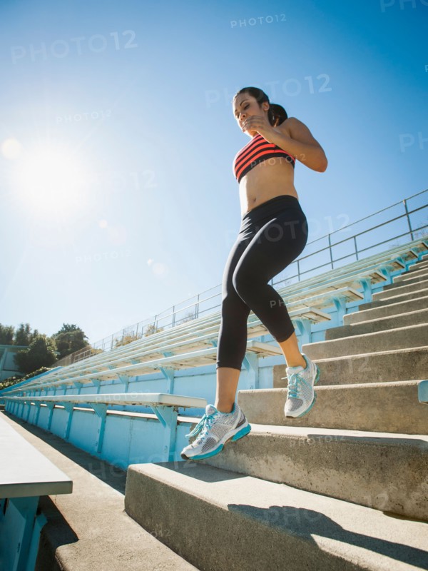 Woman jumping down steps