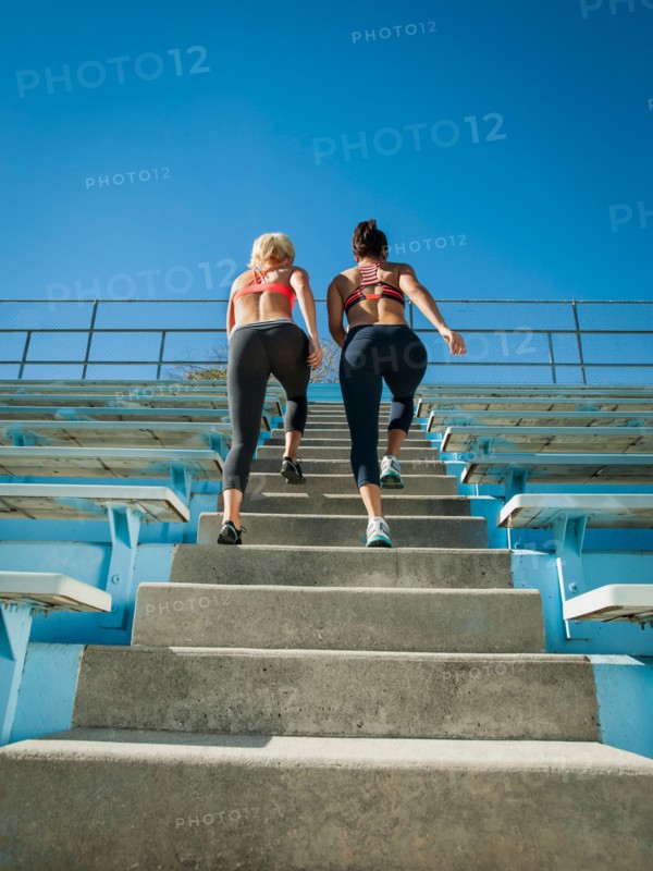Two women walking up steps