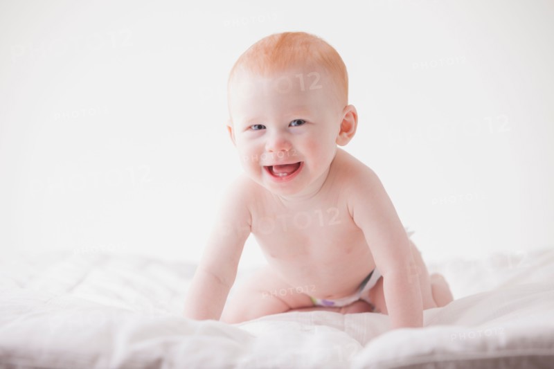 Portrait of baby boy (18-23 months) laughing