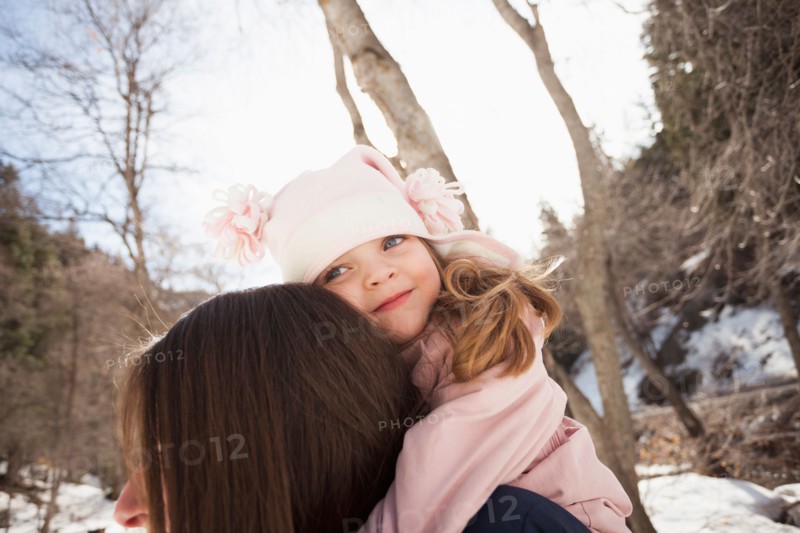 Girl (2-3) hugging her mother