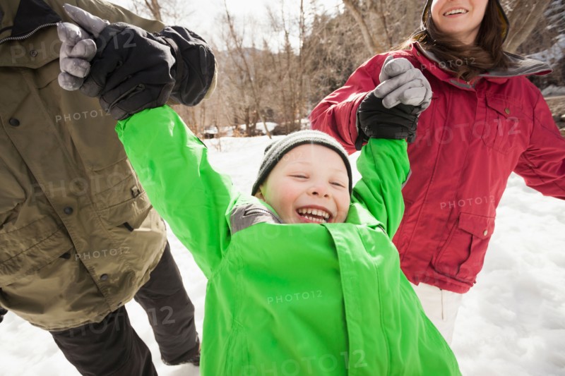 Boy (4-5) with parents during stroll