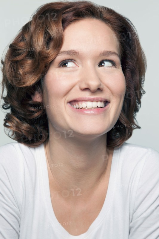 Studio shot portrait of young woman in white blouse