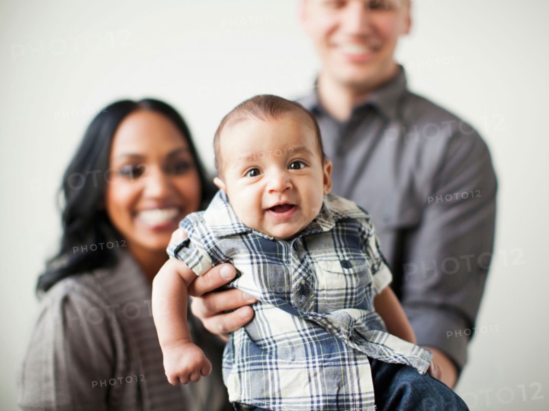 Portrait of happy multiethnic family with baby boy (2-5 months) on front