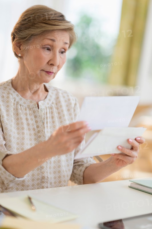 Senior woman reading letter.