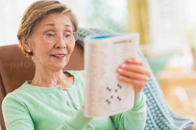 Senior woman doing crossword puzzle.