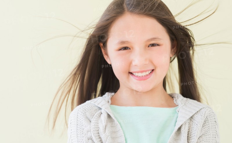 Girl (8-9) smiling, portrait.
