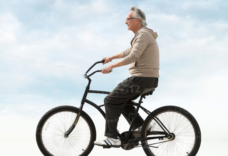 Senior man riding bicycle.