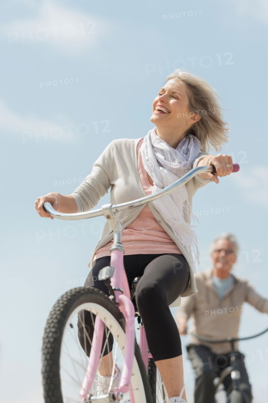 Senior couple riding bicycle.