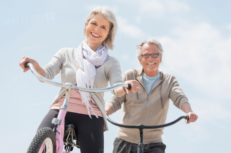 Senior couple riding bicycle.