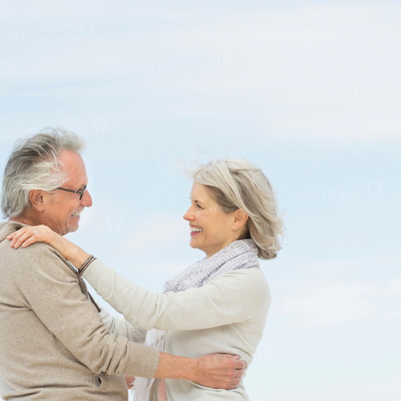 Senior couple embracing outdoors.