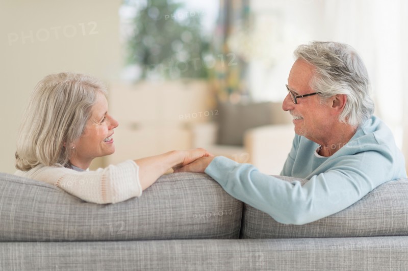 Senior couple sitting on sofa.