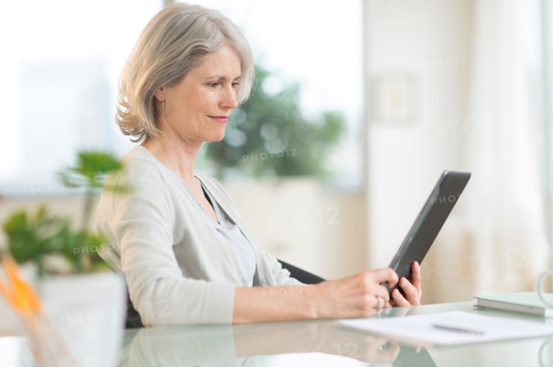 Senior woman using digital tablet.
