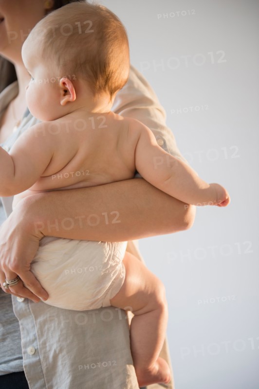 Mother holding baby girl (6-11 months)