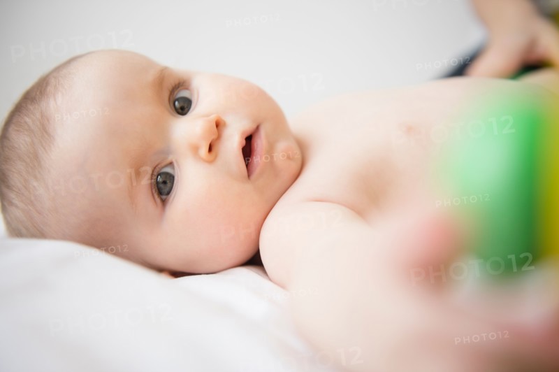 Portrait of baby girl (6-11 months) lying down