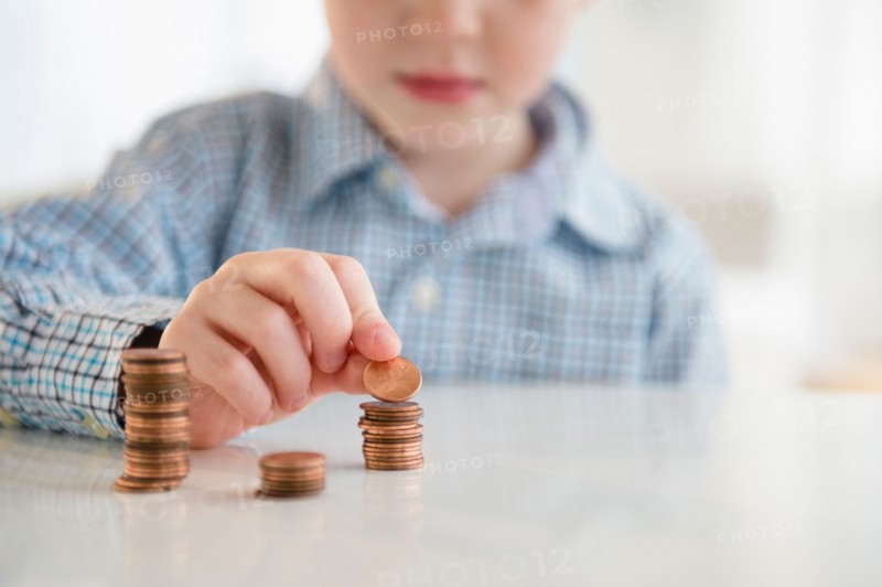 Boy (4-5) stacking coins