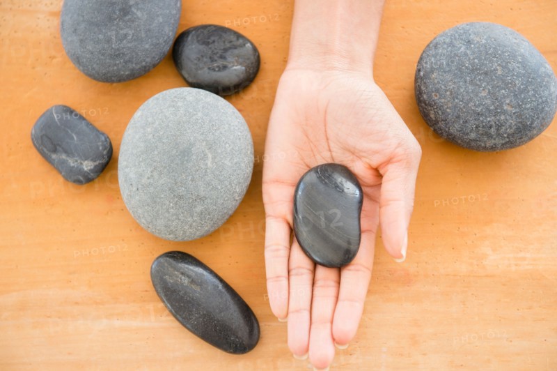 Close up of woman's hand holding pebble