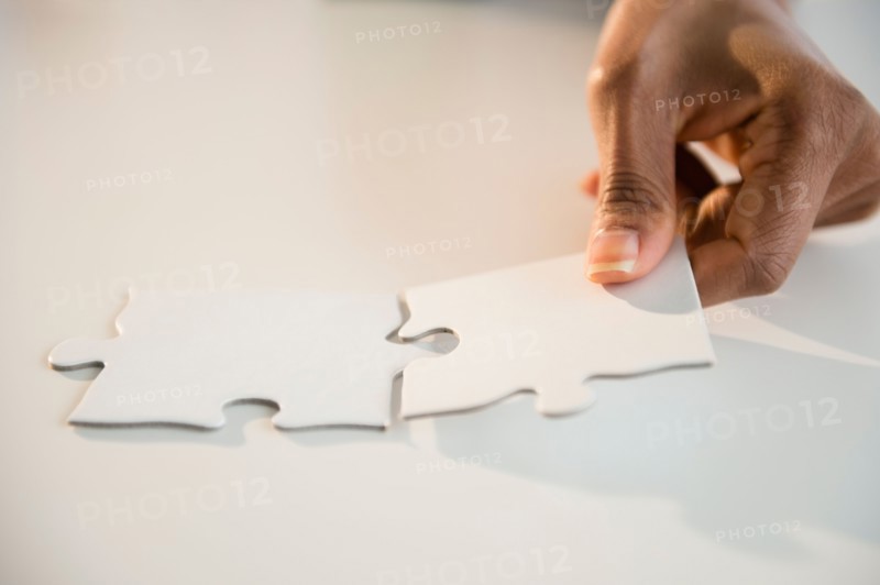 Woman's hands matching jigsaw puzzle
