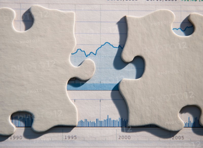 Studio Shot of financial graph and puzzle pieces